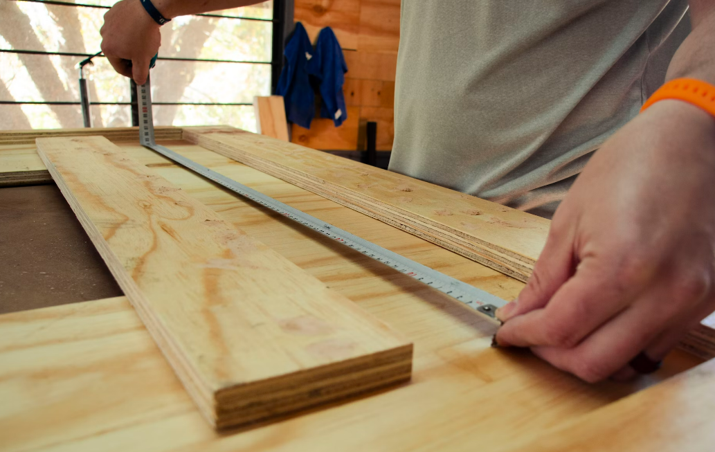Measuring plywood for a winter DIY project at home